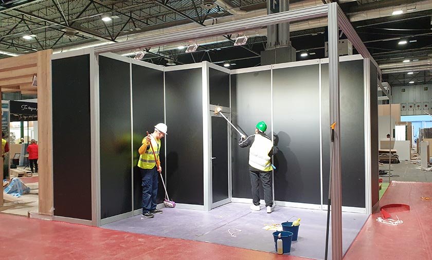 people cleaning a modular exhibition booth